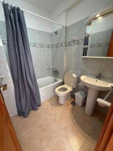 a bathroom with a toilet and a sink and a shower at VV Monica 33 "by AFCVacacional" in Puerto Naos +11 photos