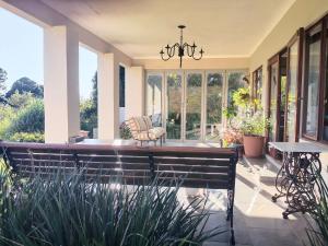a screened in porch with a bench and chairs at Valley View the home with a view in Nottingham Road
