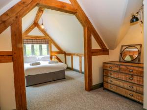 a bedroom with a bed and a dresser at Gayton Stables in Wirral