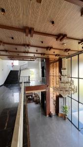 a living room with a chandelier and a staircase at Hill Turn Corbett in Rāmnagar