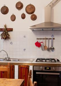 a kitchen with a sink and a stove top oven at Cristallo apartment in Ravenna