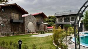 a view of a resort with a swimming pool at Hill Turn Corbett in Rāmnagar