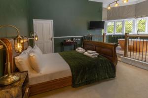 a bedroom with a bed and a bathroom with a tub at Walworth Castle Hotel, BW Signature Collection in Darlington