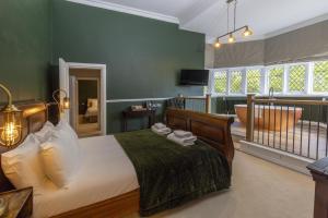 a bedroom with a large bed with green walls at Walworth Castle Hotel, BW Signature Collection in Darlington +74 photos