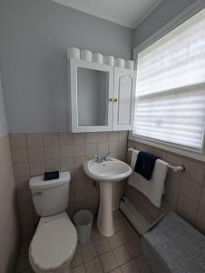 a bathroom with a toilet and a sink at St Andrews Guest Home in St. John's +27 photos