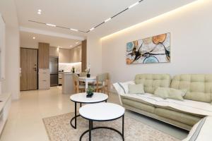a living room with a couch and a table at Alrei Apartment in Vlorë