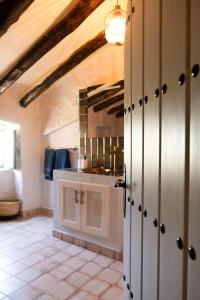 a kitchen with white cabinets and a mirror at Boutique Cortijo Meliora in Cantoria