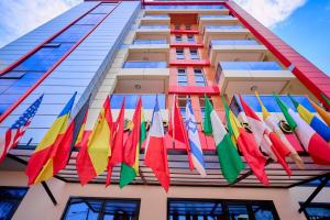a group of colorful flags hanging from a building at Empire Luxury Hotel in Yaoundé