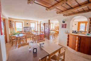 a kitchen and dining room with tables and chairs at Albergo Osteria Leso1815 in Bosco Chiesanuova +75 photos