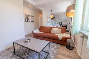 a living room with a couch and a table at Haus Kormoran Borkum in Borkum