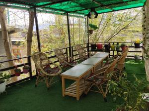 a wooden table and chairs on a patio at Stendel Villa Fort Road, Leh in Leh
