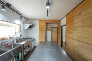 a kitchen with a stainless steel counter and wooden walls at Lake&Mountain Hamamatsu inn in Hamamatsu +45 photos