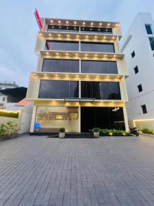 a large white building with lights on it at Hotel Calicut Beach-Silk Street in Kozhikode
