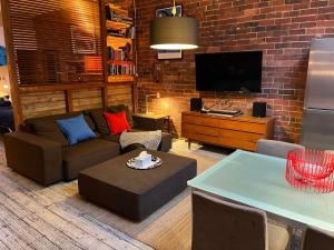 a living room with a couch and a tv at beachside loft warehouse artists retreat in Edithvale