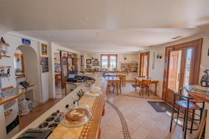 a kitchen and living room with a table and chairs at Albergo Osteria Leso1815 in Bosco Chiesanuova