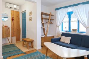 a living room with a blue couch and a table at 5 Chirpici - Small Traditional Resort in Murighiol +176 photos