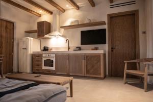 a kitchen with a white refrigerator and a sink at Elion Private Pool Villas in Kos