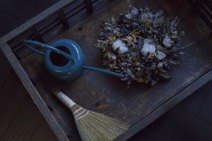 a broom sitting on a wooden table with a brush at 旧雨今雨 in Onomichi
