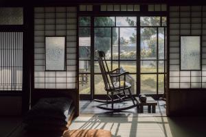a room with a rocking chair in front of a window at 旧雨今雨 in Onomichi +29 photos