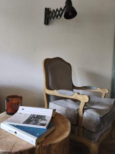 a laptop sitting on a table next to a chair at Dublinkowo in Gołubie +20 photos