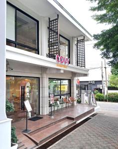 a store front with chairs and a sign on it at Chateau de Sukhumvit in Bangkok