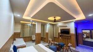 a hotel room with a bed and a tv at Sumitra Enclave in Jaipur