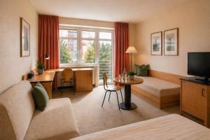 a living room with a couch and a table at Hotel Am Weberplatz in Dresden