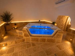 a jacuzzi tub in a room with lights at Tenuta Saracena in Ostuni