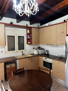 a kitchen with a table and a chandelier at Coral Bungalow in Rákhai