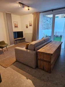 a living room with a couch and a coffee table at La Cereria INES in Chiavenna