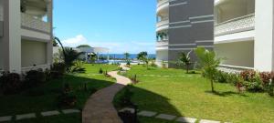 a walkway between two buildings in a yard at Easy stays baobab in Mombasa