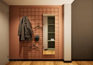 a room with a tiled wall with a mirror at Essential by Dorint Mannheim Taylor Park in Mannheim