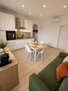 a living room with a green couch and a table at Tenuta Saracena in Ostuni