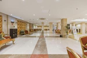 a lobby of a hospital with chairs and tables at Saraya Al Deafah Hotel in Mecca