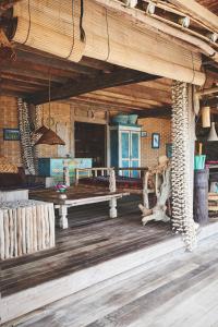 a room with a bench on a wooden floor at The Island Houses Bingin in Uluwatu