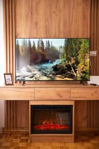 a living room with a tv and a fireplace at Apartman Gorica in Priboj