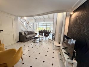 a living room with a couch and a table at Natalie Apartments Athens Airport in Artemida