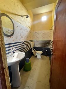 a bathroom with a sink and a toilet at Meeraj Residency in Mātigara