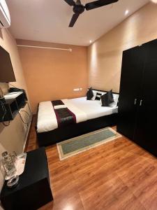 a bedroom with a bed with a ceiling fan at Meeraj Residency in Mātigara