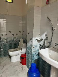 a bathroom with a toilet and a sink at Meeraj Residency in Mātigara