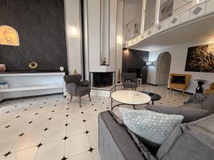 a living room with a couch and a table at Natalie Apartments Athens Airport in Artemida