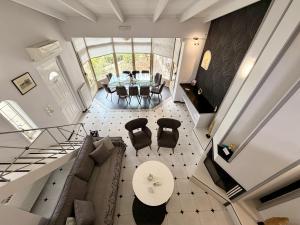an overhead view of a living room with a table and chairs at Natalie Apartments Athens Airport in Artemida
