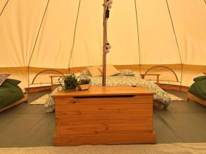 a bedroom with a bed in a tent at Walltree House Glamping - Bell Tent in Brackley