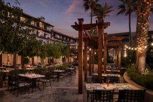 an outdoor restaurant with tables and chairs at night at Elysium in Paphos