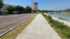 an empty parking lot next to a river with a building at Sitora in Chirchiq