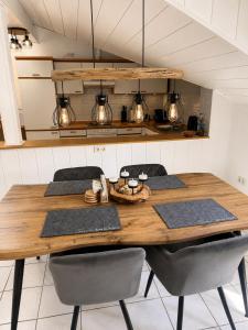 a kitchen with a wooden table and chairs at Apartment Auszeit in Ulrichstein