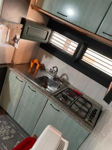 a small kitchen with a stove and a sink at Villa Iovane Diamond in Ustica