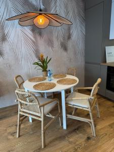 a dining room table with chairs and a ceiling at Apartament Londyn in Pniewy