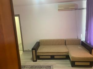 a living room with a couch and a heater at Sofia Apartament in Drobeta-Turnu Severin