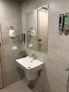 a bathroom with a sink and a mirror at The Kaksh in Greater Noida
